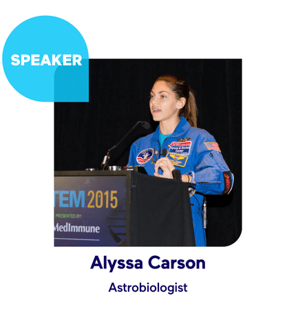 Teenager in astronaut suit speaking at a STEM event.