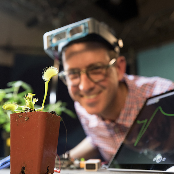 Man demonstrates plant neuroscience experiment with Venus flytrap.