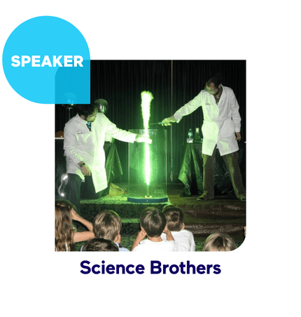 Two scientists performing an experiment with a green flame on stage.