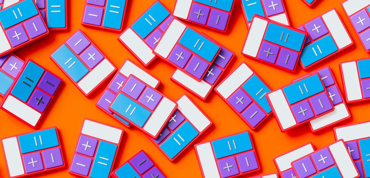 Colorful block calculators on orange background.