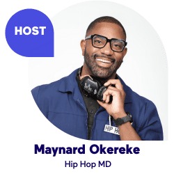 Smiling man in blue jacket and glasses with headphones.