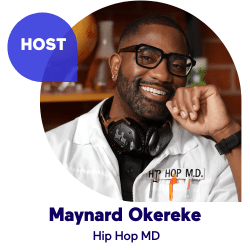 Man with glasses smiling, wearing headphones and a lab coat.