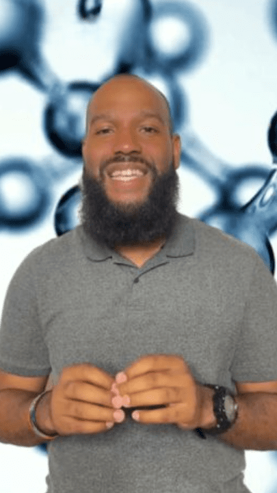 Smiling person with a beard in front of molecular structure background.