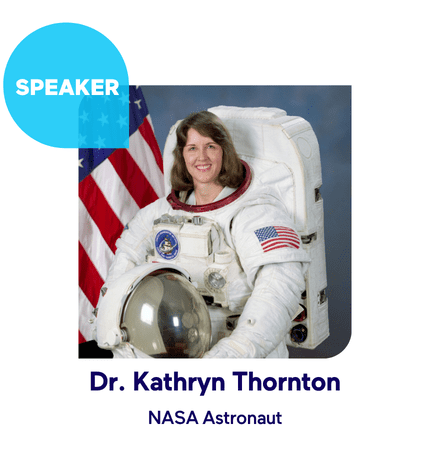 Astronaut in a space suit with an American flag backdrop.