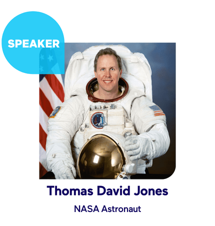 Astronaut in space suit with American flag backdrop.