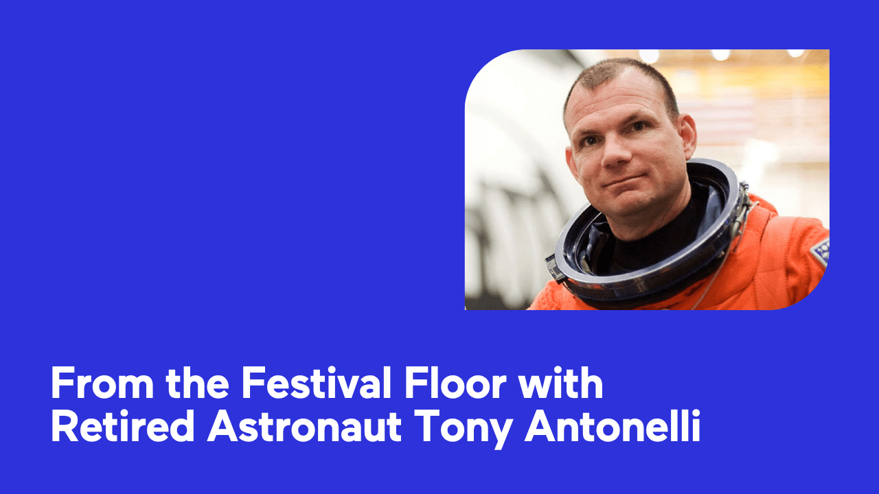 Portrait of a man in an orange astronaut suit on a blue background