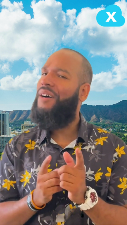 Man in floral shirt gesturing with Honolulu skyline and mountains behind