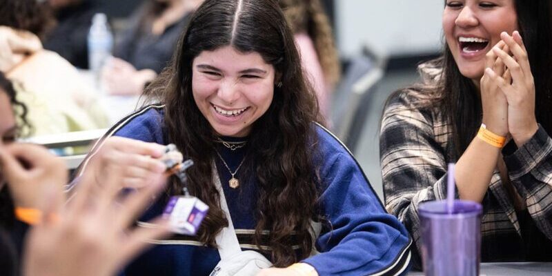 Happy young women smiling and laughing during an activity.