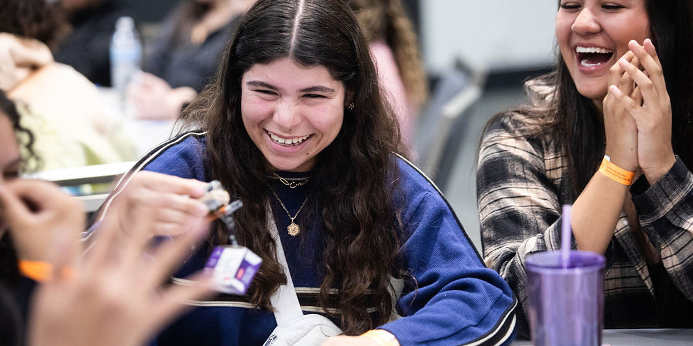 Happy young women smiling and laughing during an activity.