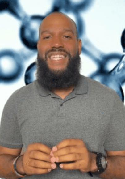 Smiling person with a beard in front of molecular structure background.