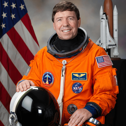Astronaut in orange suit with helmet and space shuttle model