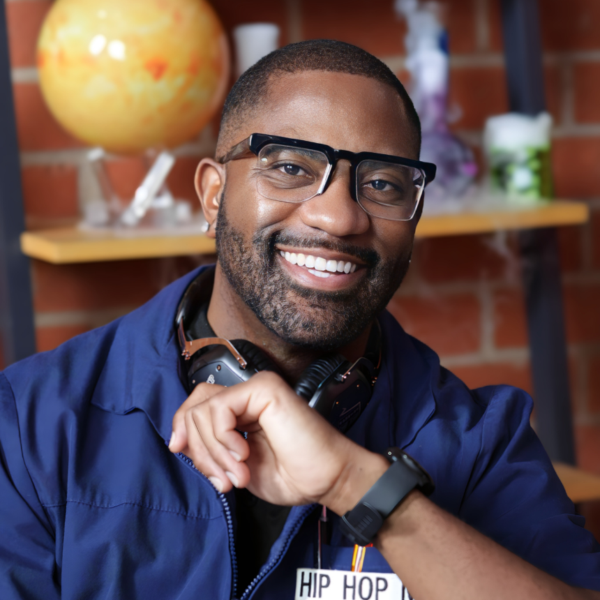Smiling man with glasses and headphones in a casual setting