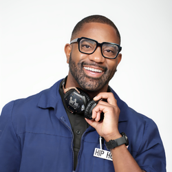Smiling man in blue jacket with headphones around neck