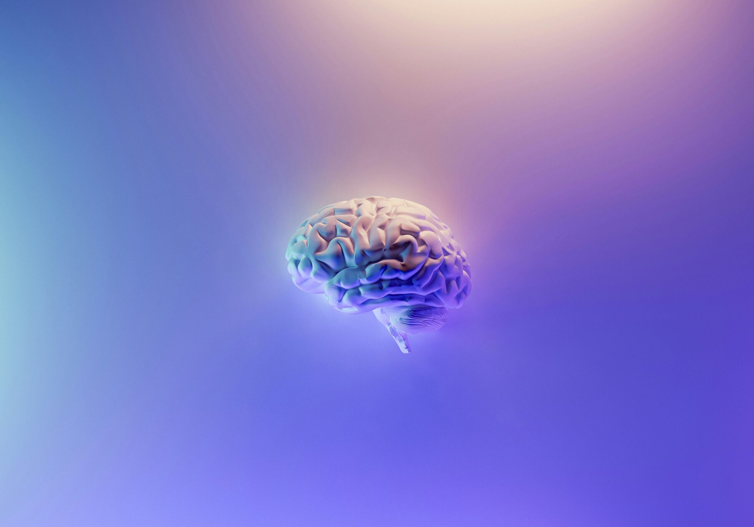 A glowing 3D human brain model on a purple background.
